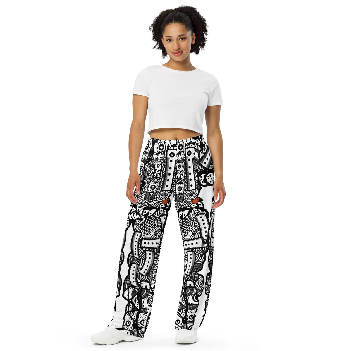 Front view of Totem Drift wide-leg pants with an all-over abstract black-and-white pattern and small orange accents.