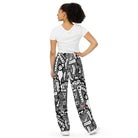 Front view of Totem Drift wide-leg pants with an all-over abstract black-and-white pattern and small orange accents.