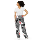Back side. Urban Highrise Signal wide-leg pants with an abstract black-and-white city pattern and red skateboard motifs.