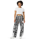 Front view of Totem Drift wide-leg pants with an all-over abstract black-and-white pattern and small orange accents.