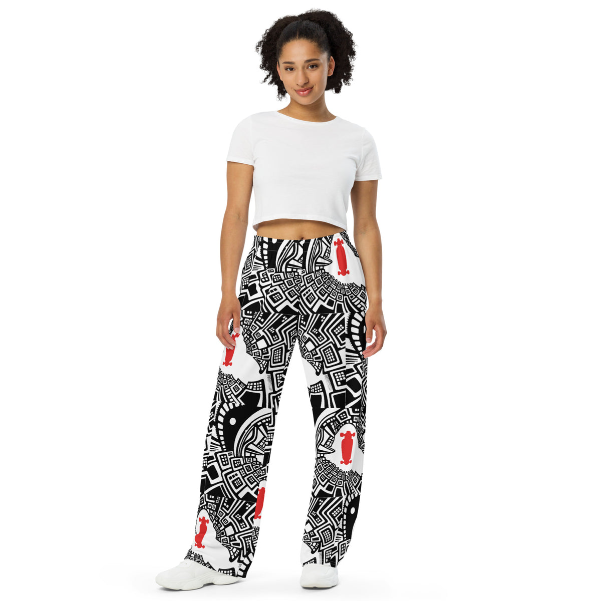 Urban Highrise Signal wide-leg pants with an abstract black-and-white city pattern and red skateboard motifs.
