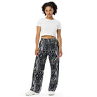 Wide-leg trousers featuring an all-over repeating abstract skateboard and wood-grain graphic pattern rendered in monochrome black, grey, and white tones.