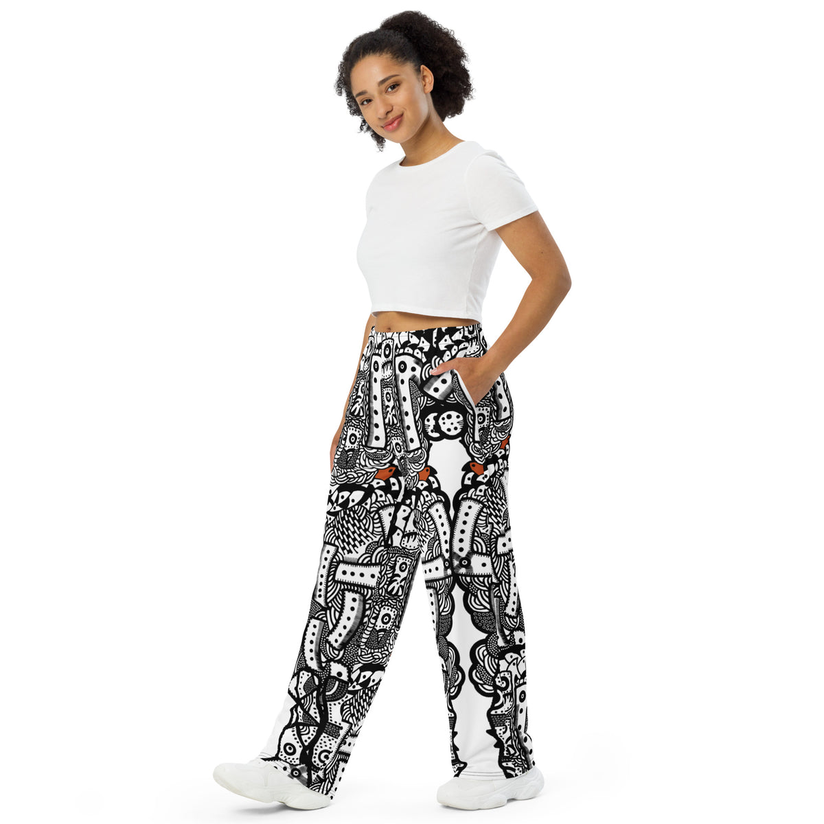 Front view of Totem Drift wide-leg pants with an all-over abstract black-and-white pattern and small orange accents.