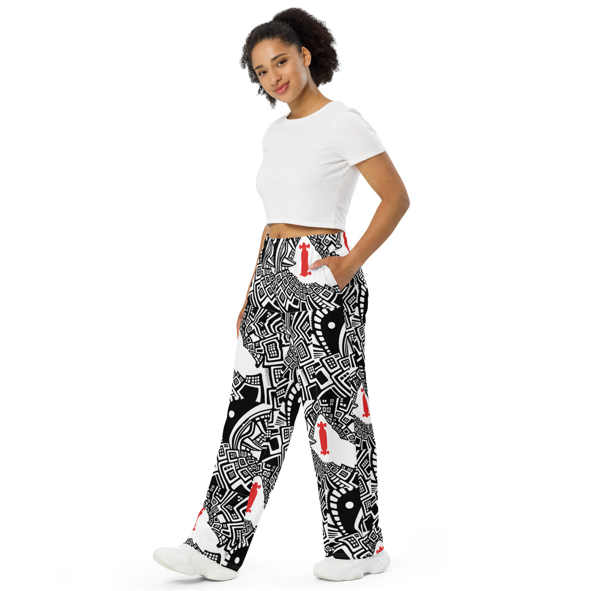 Urban Highrise Signal wide-leg pants with an abstract black-and-white city pattern and red skateboard motifs.