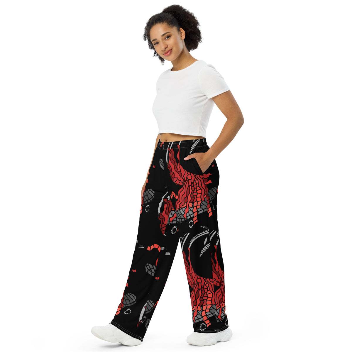Wide-leg trousers featuring an abstract graphic of a black shadowed watcher figure riding a grey brick-patterned skateboard with red flowing ribbon-like strands extending downward.