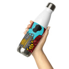 Stainless steel water bottle with an abstract city graphic and a black skateboard flying across a turquoise sky.
